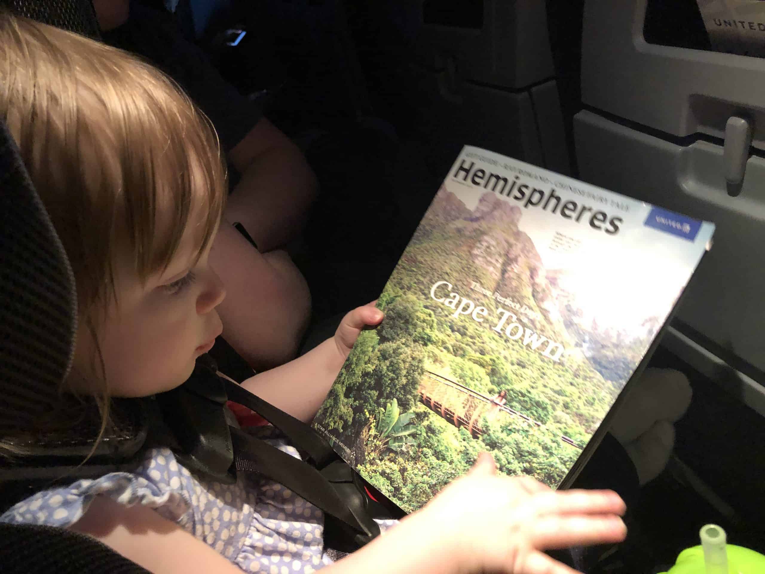Leah catching up on reading in the airplane